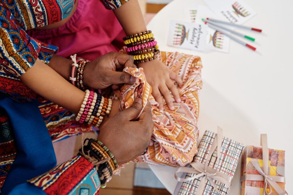 Photo Of Hands On Top Of Gift Wrapped In A Cloth