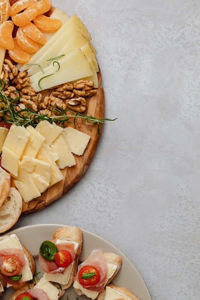 An Assorted Food on a Charcuterie Board and Ceramic Plate